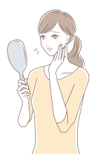 鏡を見ながら不安そうな様子の女性